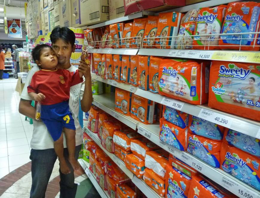 Growth market: A father and his son look for disposable paper diapers at a supermarket in Jakarta. Japanese diaper makers are banking on growing demand for their products in other Asian economies.